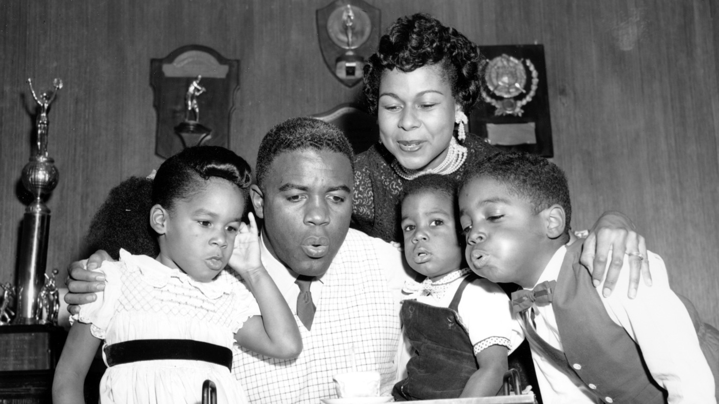 Jackie Robinson draws his family close to help him blow out a birthday candle in 1954. Jackie and his wife Rachel had 3 children and he was definitely a family man!